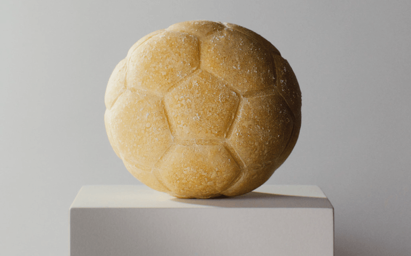 Football shaped dough ball on plinth